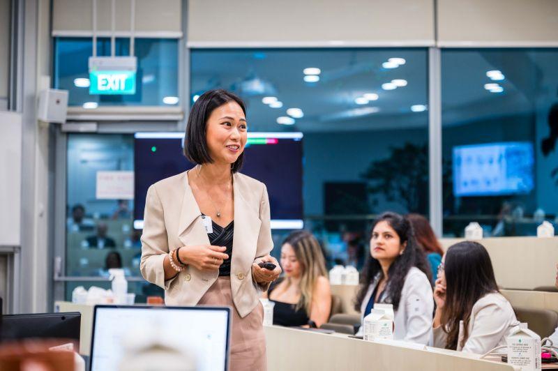 Professional woman presenting to classroom audience